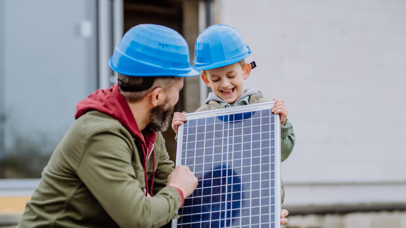 Close Up Of Father And His Little Son Holding Solar Panel,In Front Of (1)
